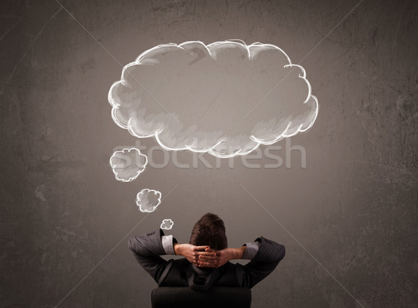 Businessman sitting with cloud thought above his head Stock photo © ra2studio