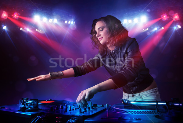 Teenager Dj mixing records in front of a crowd on stage Stock photo © ra2studio