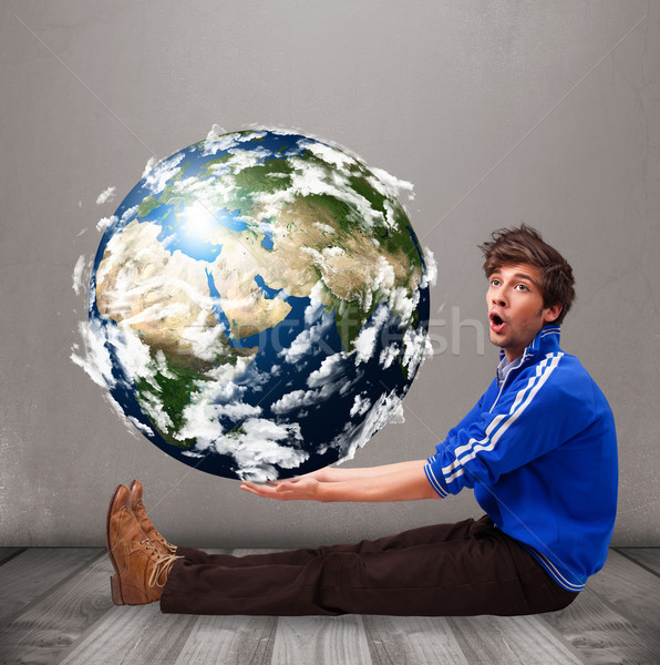 Stock photo: Good-looking man holding 3d planet earth