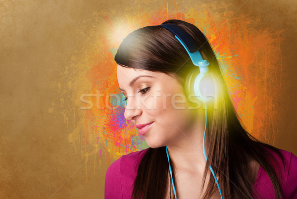 Young woman with headphones listening to music Stock photo © ra2studio