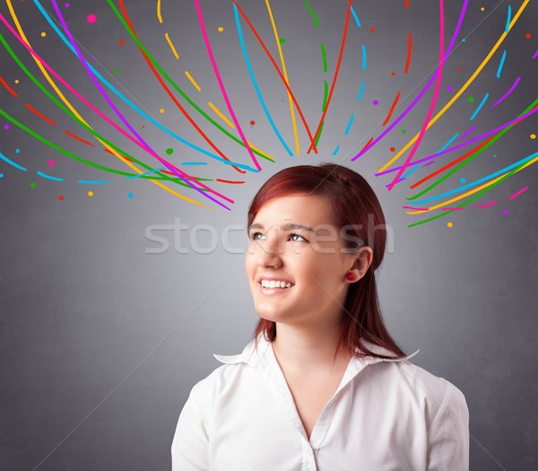 Young girl thinking with colorful abstract lines overhead Stock photo © ra2studio