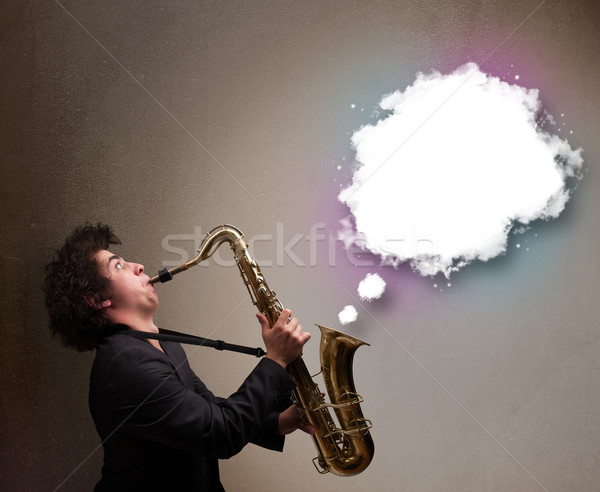 Young man playing on saxophone with copy space in white cloud Stock photo © ra2studio