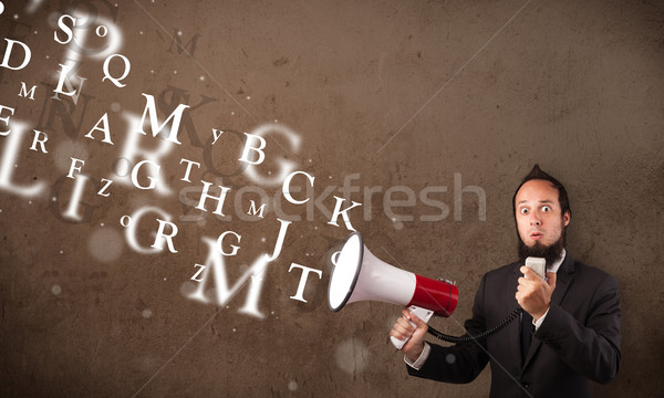 Man in shirt shouting into megaphone and text come out Stock photo © ra2studio