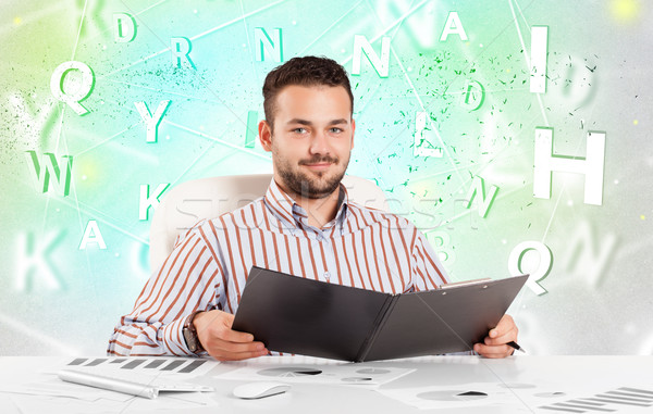 Business man at desk with green word cloud Stock photo © ra2studio