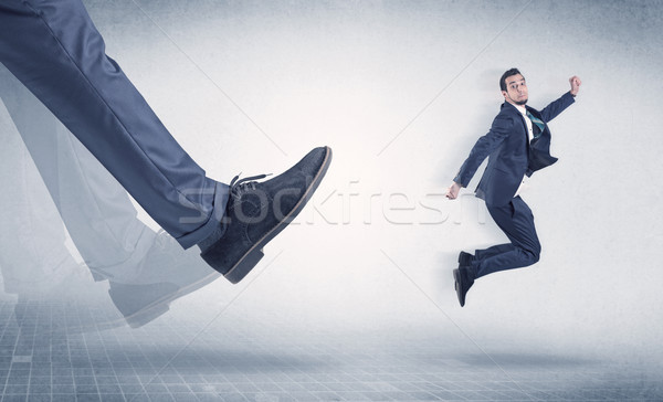 Businessman foot kicking small businessman Stock photo © ra2studio