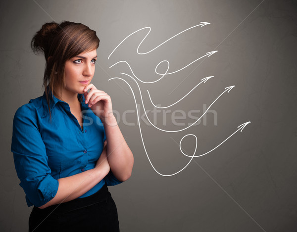 Attractive teenager looking at multiple curly arrows Stock photo © ra2studio