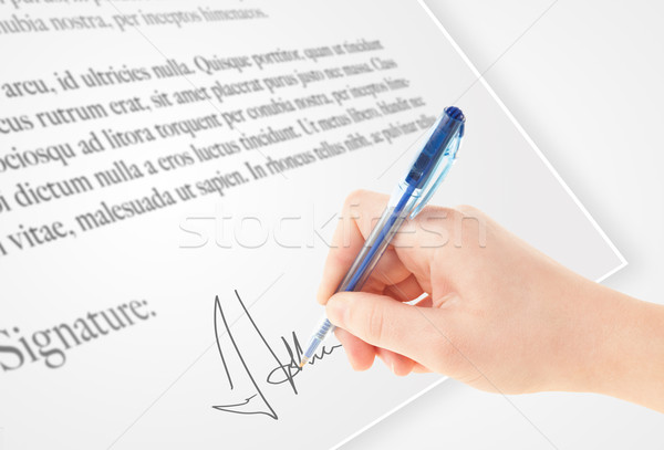 Hand writing personal signature on a paper form Stock photo © ra2studio