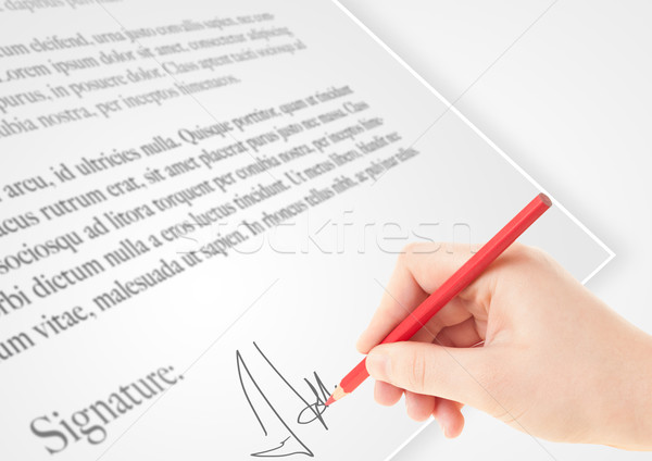 Hand writing personal signature on a paper form Stock photo © ra2studio