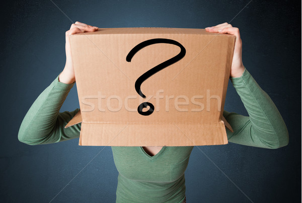 Young lady gesturing with a cardboard box on her head with quest Stock photo © ra2studio