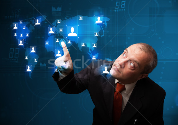 Businessman choosing from social network map Stock photo © ra2studio