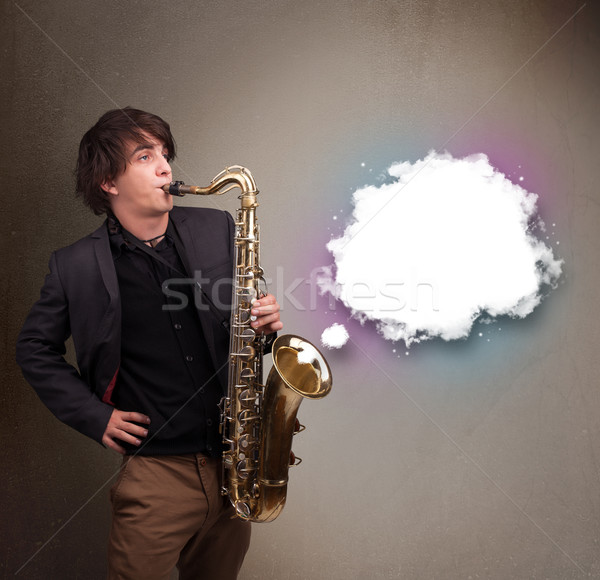 Young man playing on saxophone with copy space in white cloud Stock photo © ra2studio