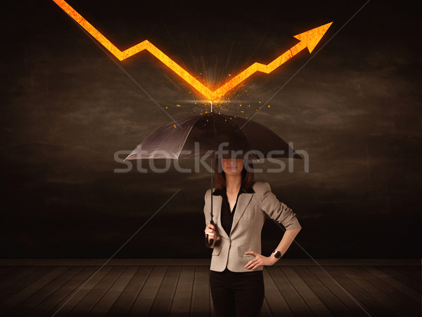 Businesswoman standing with umbrella keeping orange arrow  Stock photo © ra2studio