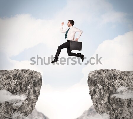 Businessman on rock mountain Stock photo © ra2studio