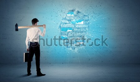 Business man hitting brick wall with huge hammer Stock photo © ra2studio