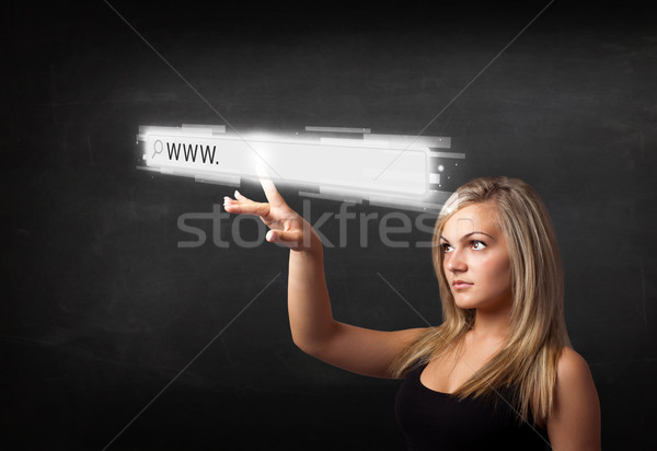 Young businesswoman touching web browser address bar with www si Stock photo © ra2studio