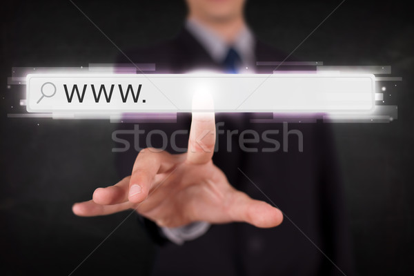 Młodych biznesmen dotknąć internetowych przeglądarka adres Zdjęcia stock © ra2studio