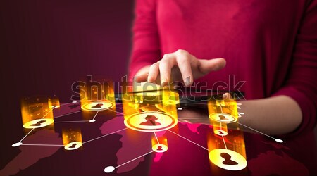 Hand holding tablet device with social network map Stock photo © ra2studio