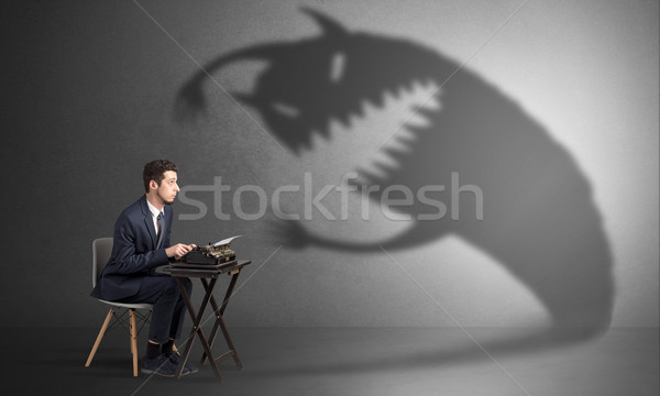 Stock photo: Hard worker afraid of scary monster