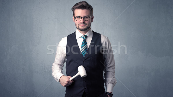 Businesman standing with tool on his hand Stock photo © ra2studio