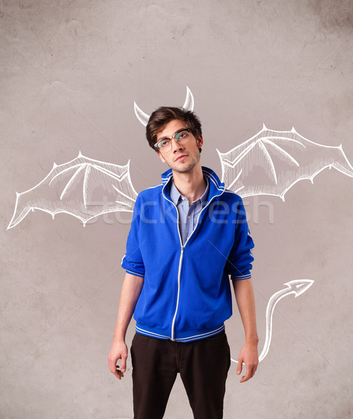 Young man with devil horns and wings drawing Stock photo © ra2studio