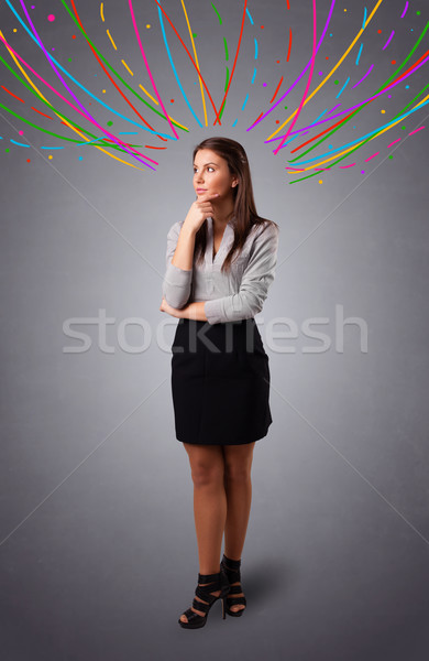 Young girl thinking with colorful abstract lines overhead Stock photo © ra2studio