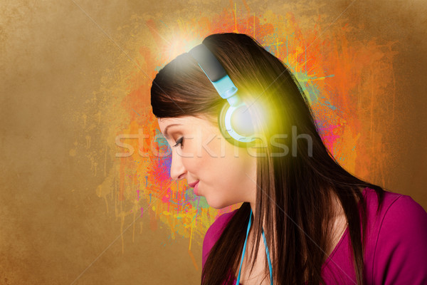 Young woman with headphones listening to music Stock photo © ra2studio