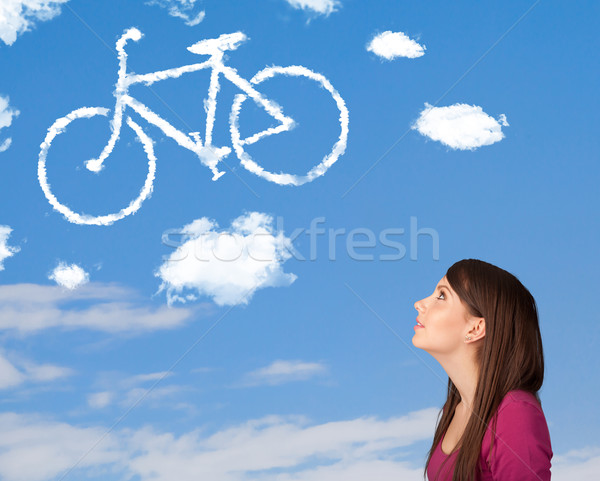 Młoda dziewczyna patrząc rower chmury Błękitne niebo młodych Zdjęcia stock © ra2studio