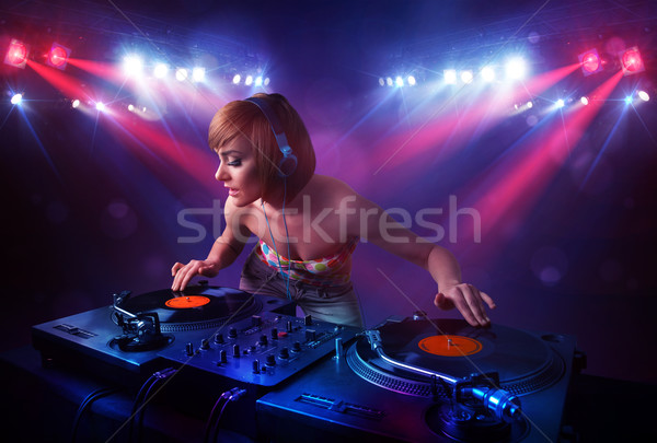 Teenager Dj mixing records in front of a crowd on stage Stock photo © ra2studio