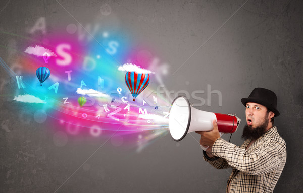 Man shouting into megaphone and abstract text and balloons come  Stock photo © ra2studio
