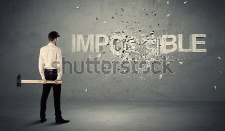 Businessman standing in front of an empty wall Stock photo © ra2studio