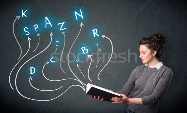 Stock photo: Pretty woman reading a book while multiple choices are coming ou