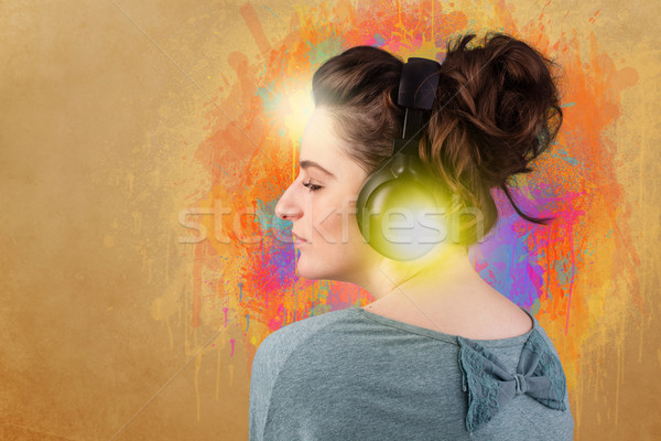 Young woman with headphones listening to music Stock photo © ra2studio