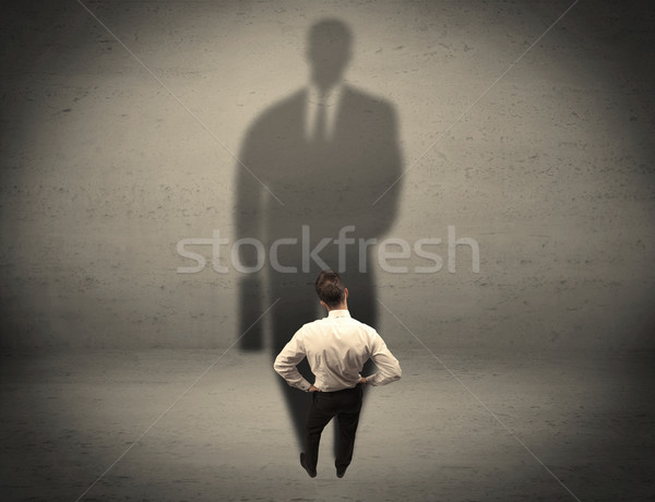 Businessman looking at big shadow concept Stock photo © ra2studio