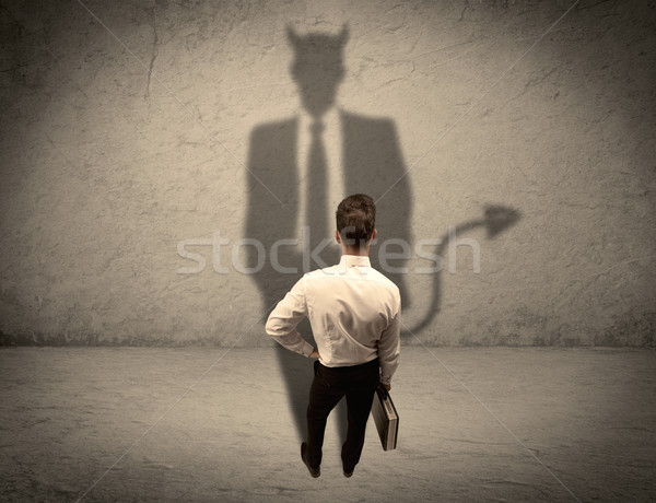 Salesman facing his own devil shadow Stock photo © ra2studio