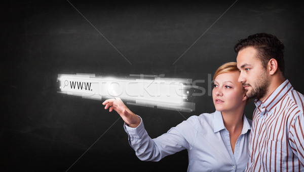 Jeunes affaires couple toucher web navigateur Photo stock © ra2studio