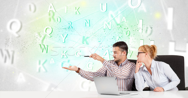 Business people at desk with green word cloud Stock photo © ra2studio