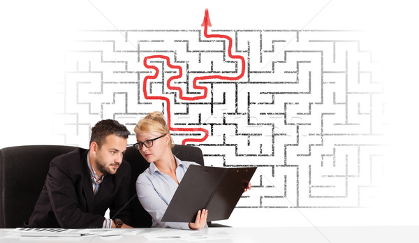 Business persons at desk with labyrinth and arrow Stock photo © ra2studio