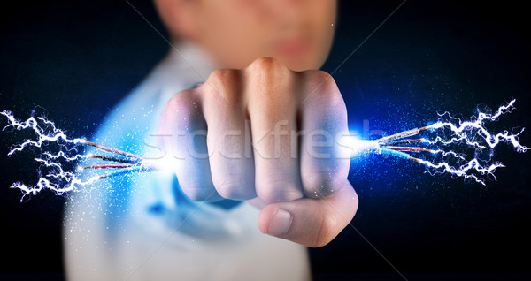 Business person holding electrical powered wires Stock photo © ra2studio