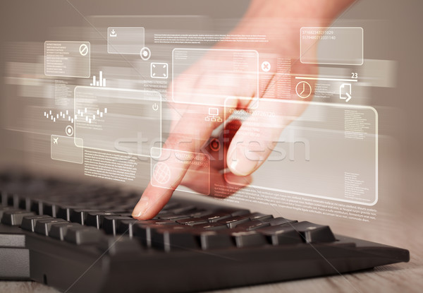 Hand touching keyboard with high tech buttons Stock photo © ra2studio