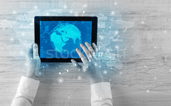 Hand holding tablet with global reports and stock market change  Stock photo © ra2studio