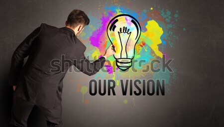 Stock photo: Man sitting on cloud looking at a lightbulb