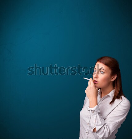 Beautiful woman smoking cigarette vith copy space Stock photo © ra2studio