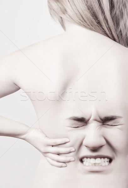 Woman with back pains Stock photo © ra2studio