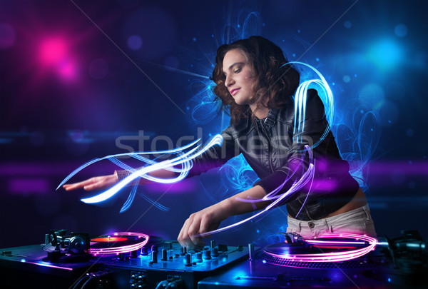 Disc jockey playing music with electro light effects and lights Stock photo © ra2studio