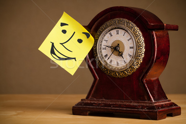 Post-it note with smiley face sticked on a clock Stock photo © ra2studio