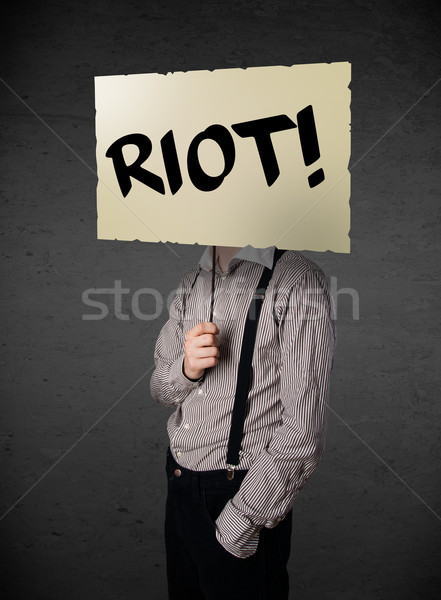 Businessman holding a protest sign Stock photo © ra2studio