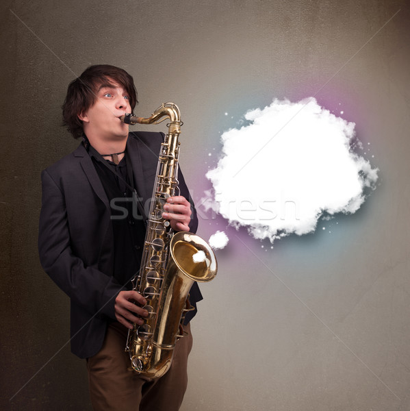 Young man playing on saxophone with copy space in white cloud Stock photo © ra2studio