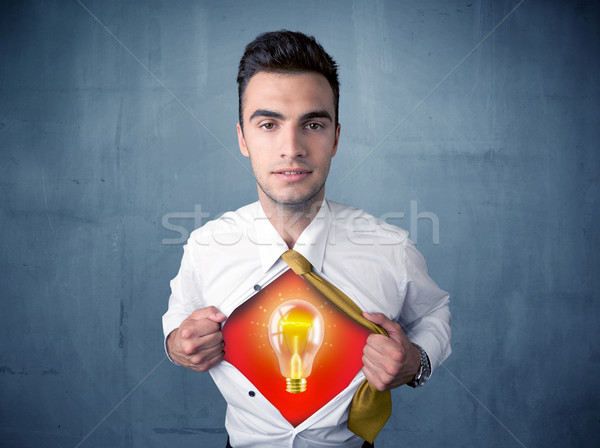 Businessman ripping off shirt and idea light bulb appears  Stock photo © ra2studio