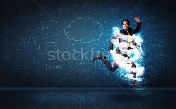 Happy business man jumping with storm cloud around him  Stock photo © ra2studio