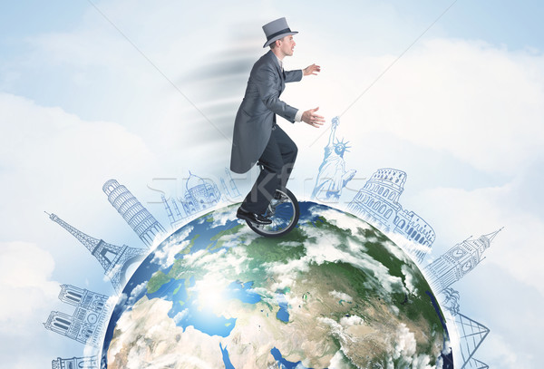 Man riding unicycle around the globe with major cities Stock photo © ra2studio